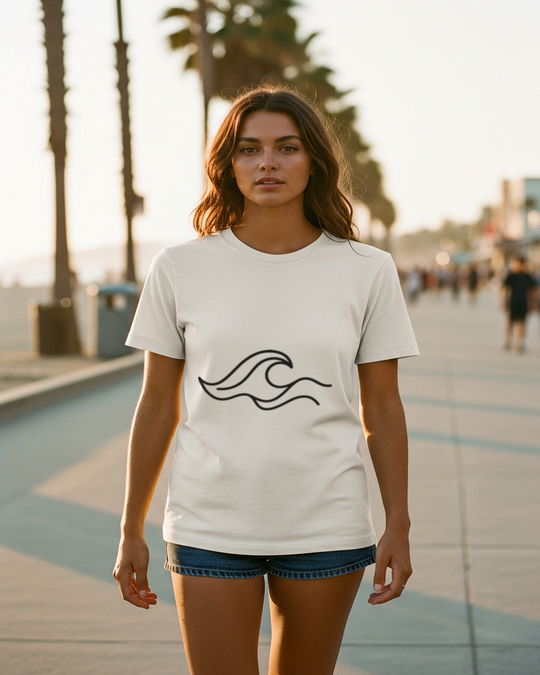 One-Line Wave California Tee worn by female model on Venice Beach boardwalk, Bella+Canvas 3001 bone white, handcrafted by Cali Life Co.